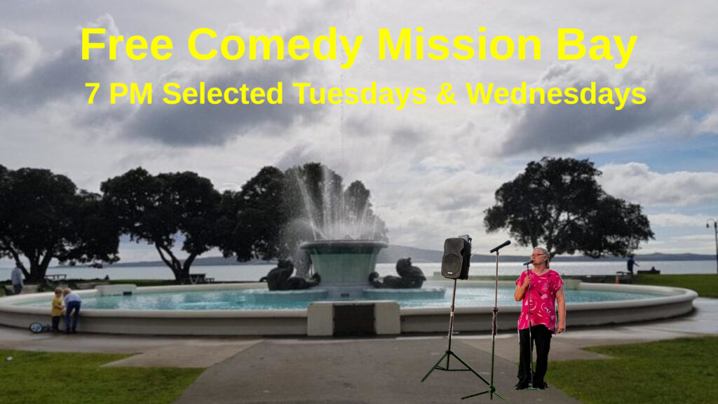 A comedian stands beside a large fountain on the foreshore at Mission Bay.