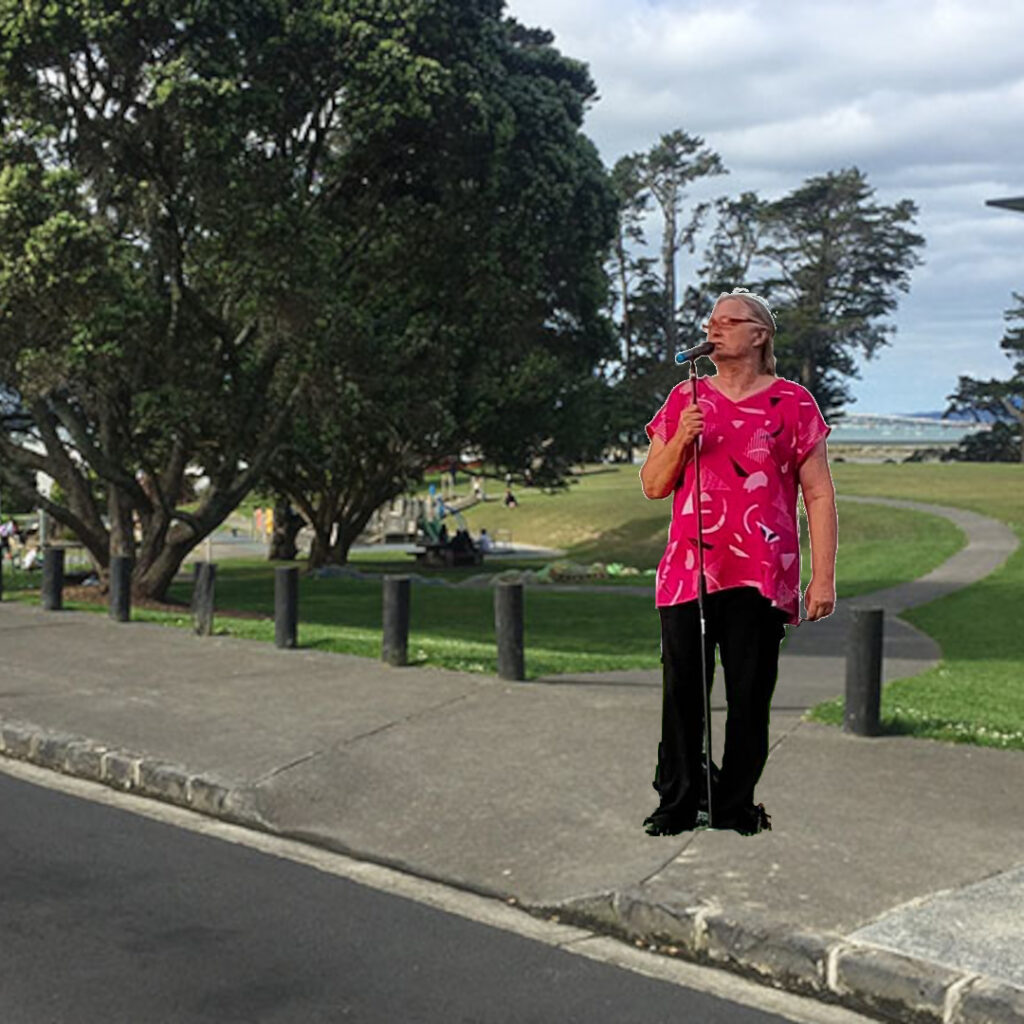 A comedian stands outside a park