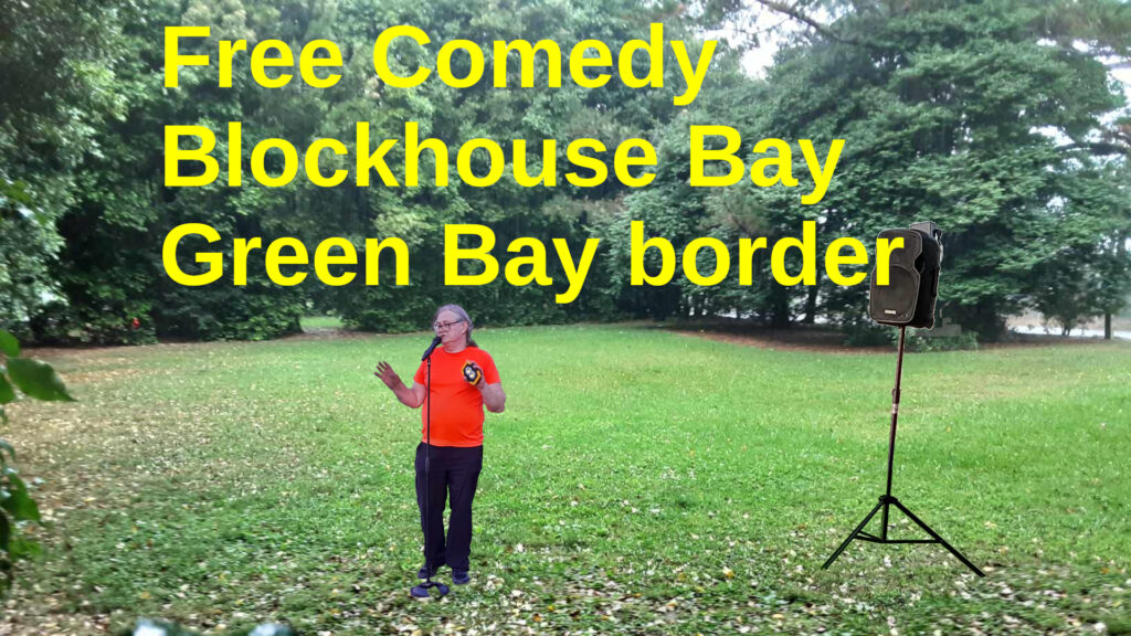 A Comedian stands in a park in front of a loudspeaker. Text: Free Comedy Blockhouse Bay, Green Bay border.