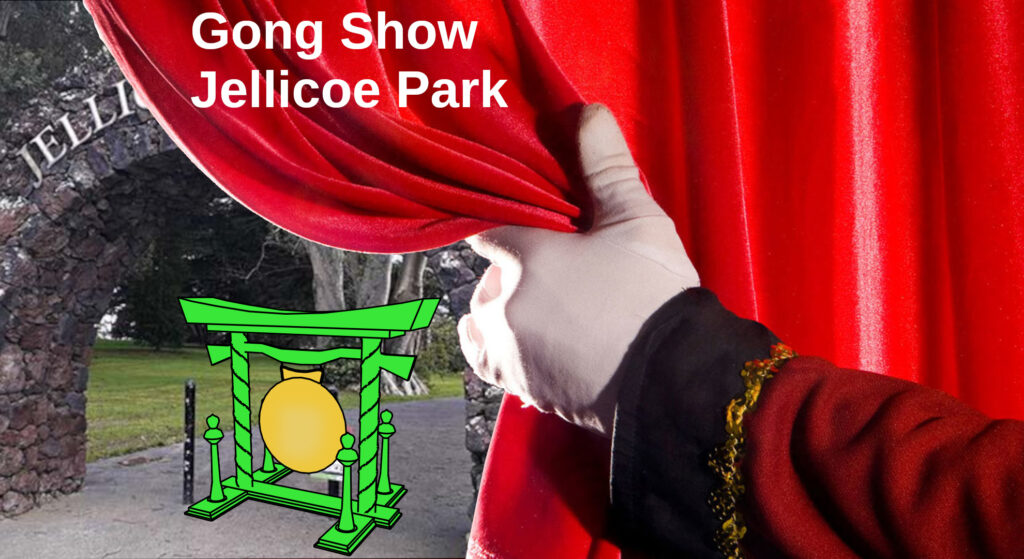 A gloved hand pulls back a curtain to reveal a large gong under the Memoria Arch in Jellicoe Park Onehunga. Text: Gong Show Jellicoe Park